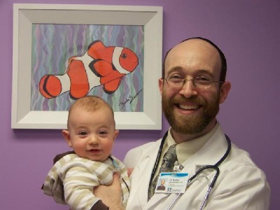 Dr. Rodbell holding his son Zevi, age 5 months